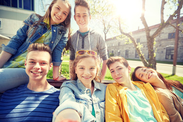 education, high school and people concept - group of happy teenage students or friends taking selfie