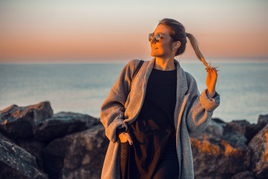Portrait of woman wearing sunglasses and winter coat looking away smiling, Odessa, Odeska Oblast, Ukraine, Eastern Europe
