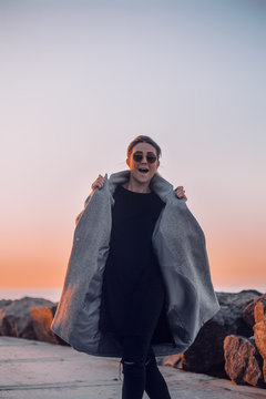 Portrait of woman wearing sunglasses and winter coat posing for camera, Odessa, Odeska Oblast, Ukraine, Eastern Europe
