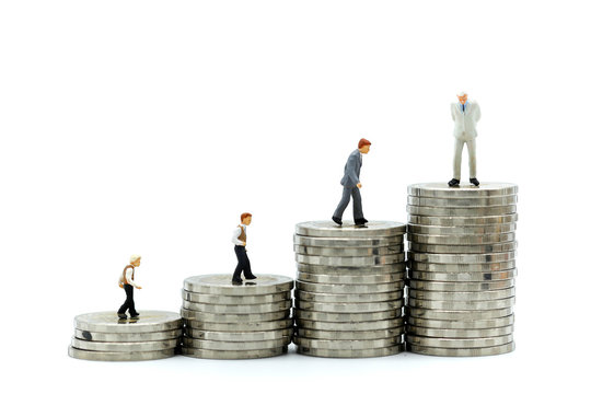 Miniature people : young businessman standing on stack of coins  with Successful businessman,Business Growth concept.