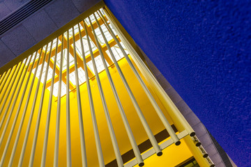 Angled view of skylight window with blue and yellow walls, modern interior architecture