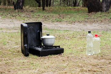 Portable gas cooker and a bowler in the open air.