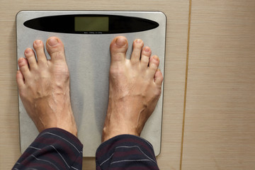 Man's leg on a scale.