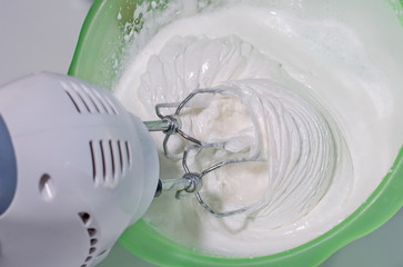 Electric mixer whips cream.