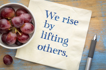 We rise by lifting others - wisdom quote on napkin