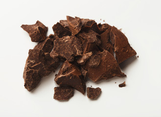 Heap of chocolate pieces isolated on white
