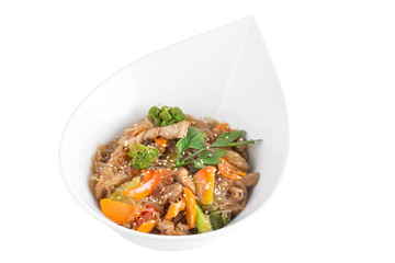 Rice noodles with meat and vegetables under teriyaki sauce isolated on white background. Rice noodles in a white plate.