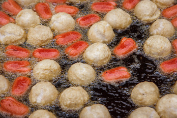 Fried fish meatballs frying at the Wat Intharawihan Temple, Bangkok, Thailand