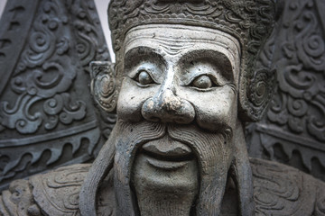 Fototapeta na wymiar Chinese stone statue at the Wat Pho Temple, Bangkok, Thailand
