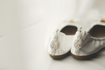 White stylish wedding shoes for bride. Close-up