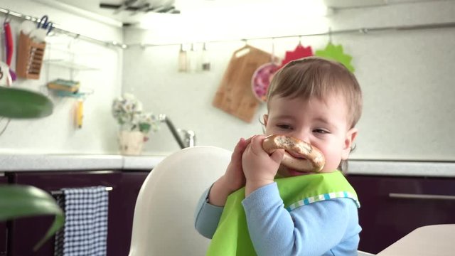 Little boy eating a bagel
