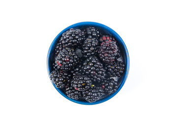 Fresh blackberries, on plate on Isolated white background. Berries