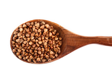 buckwheat in wooden spoon on white background. Isolate. Top view