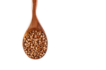 buckwheat in wooden spoon on white background. Isolate. Top view