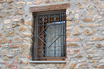 window with iron grating on old stone wall - 201086052