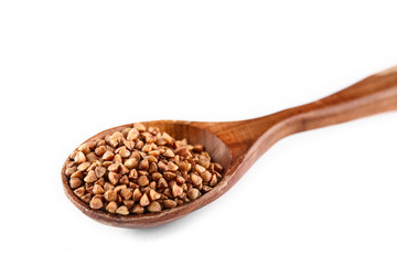 buckwheat in wooden spoon on white background. Isolate. Top view