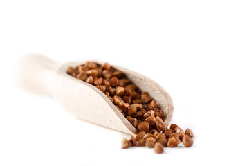 Obraz premium buckwheat in wooden scoop on white background. Isolate