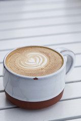 Latte with Heart Shaped Foam on White Table