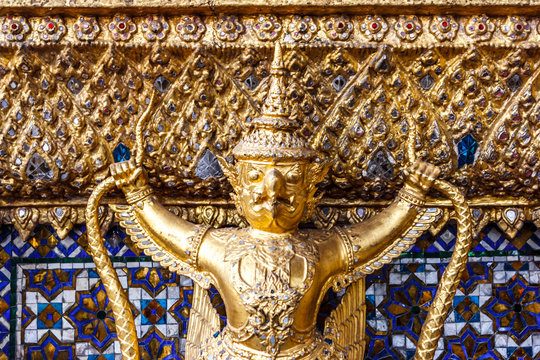 Demon statue at the Ubosoth the main temple in the Wat Phra Kaew Palace, also known as the Emerald Buddha Temple. Bangkok, Thailand. - Powered by Adobe