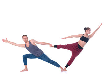 Young athletic couple practicing acroyoga. Balancing in pair