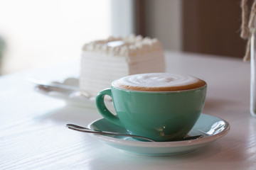 Coffee and cake on a white table.