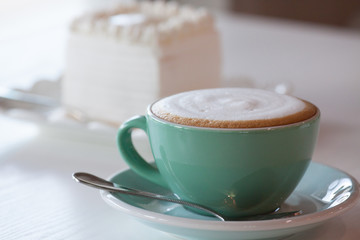 Coffee and cake on a white table.