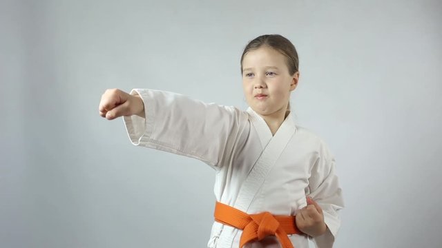 In karategi the girl beats a blow with her hand