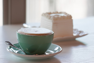 Coffee and cake on a white table.
