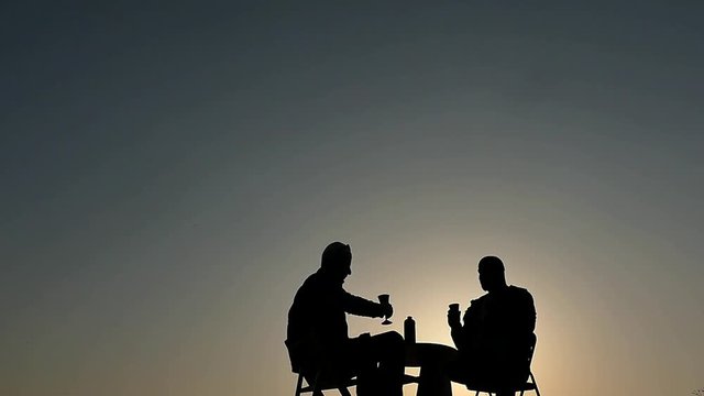 2 men drinking vine silhouettes slow motion