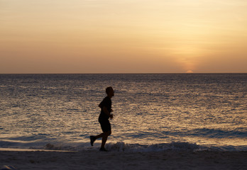 Runner on the beach at sunset