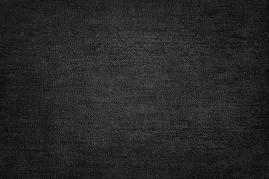 Black jeans texture. Dark fabric background.