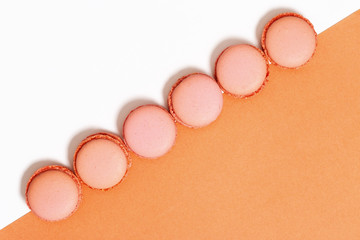 Sweet orange macaroons. Minimal concepts pattern. Food background.