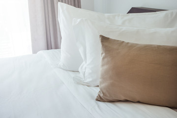 white pillows and bed sheets in beauty room