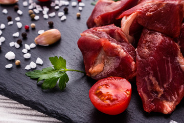 fresh lamb meat on a textured stone plate