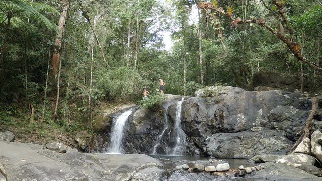 Boys jump from rocks at Salakot Waterfalls, Napsan, Palawan