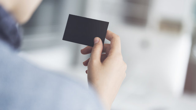 Woman holding the business card