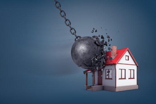 3d rendering of a giant wrecking ball breaks in small pieces when hits a small family house.