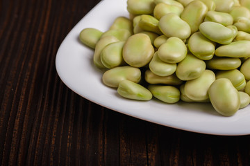 fresh broad beans on a rustic background