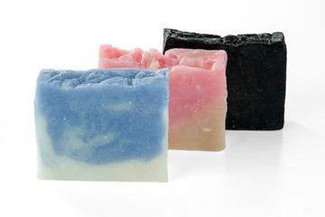 Three different handmade soap bars isolated on white background.