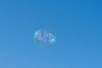 Soap bubble on blue sky background