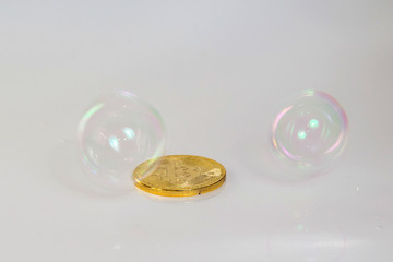 Golden bitcoin coin and soap bubble