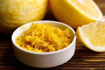 Lemon and juice on a wooden background
