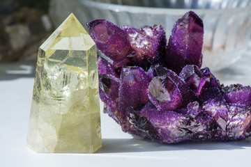 Fototapeta premium Citrine stone and amethyst. Yellow, clear crystal with dark, smokey color, smoky quartz with ornaments and rainbows in it. Amethyst is a violet variety of quartz used in jewelry. Meditative, powerful