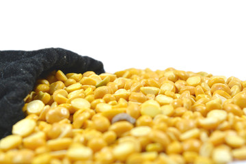 Full of Arhar or masoor Dhal or Toor Dal Pigeon Pea in bag and some tool dal on floor