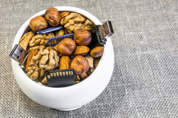 Composition of nuts and memory cards. Symbolizes the useful properties of nuts to improve human memory.