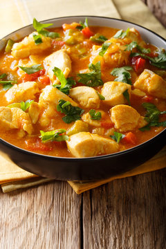 Brazilian traditional Bobo chicken with vegetables in coconut milk close-up in a bowl on the table. vertical
