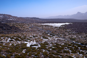 The peak of Teida volcano covered with snow. Lava and snow