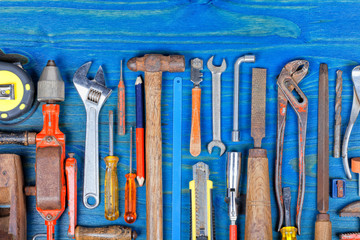 Many manual tools on wood painted blue color