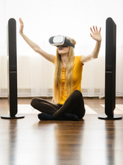 Girl wearing virtual reality goggles at home