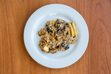 Homemade oatmeal cookies on plate on the wooden table.
